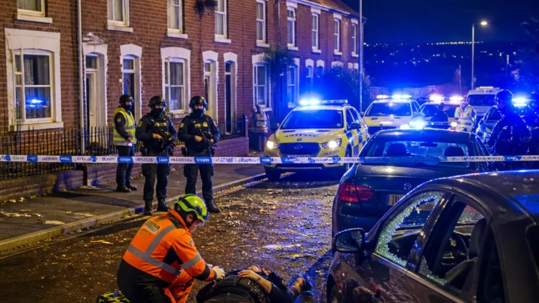 Man arrested after roof-top standoff in north Belfast leaves officer injured and seven cars damaged